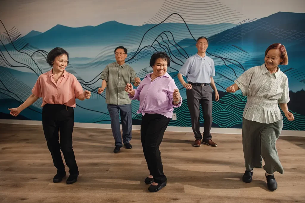 A woman practicing tai chi in a community class